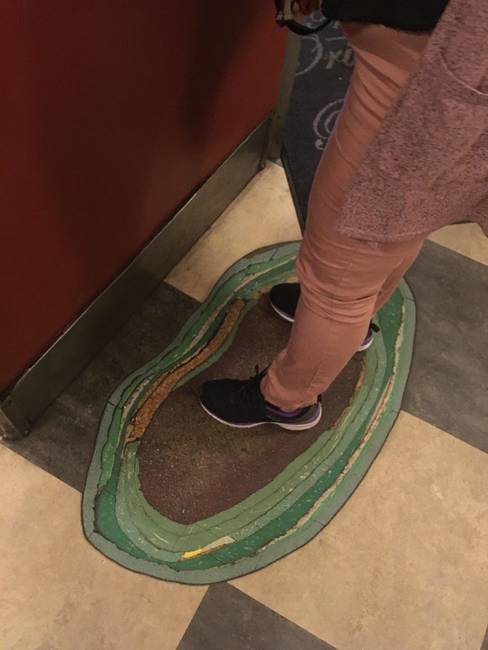 Az évek során lerakott és kikopott padlók egy pénztár előtt.
