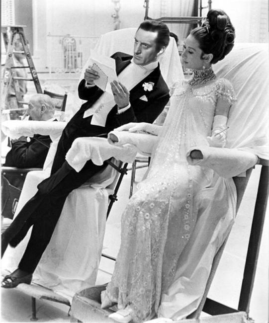 Rex Harrison és Audrey Hepburn a "My Fair Lady" film forgatásán, 1960-ban. Nem ültek le teljesen a székekre, inkább csak támaszkodtak azokon, nehogy tönkre tegyék a méregdrága ruhákat, amiket viselnek.